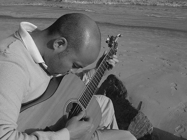 Ernest playing an acoustic guitar